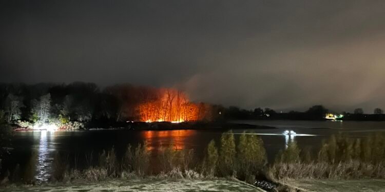 Witness watches people set Henderson Island on fire