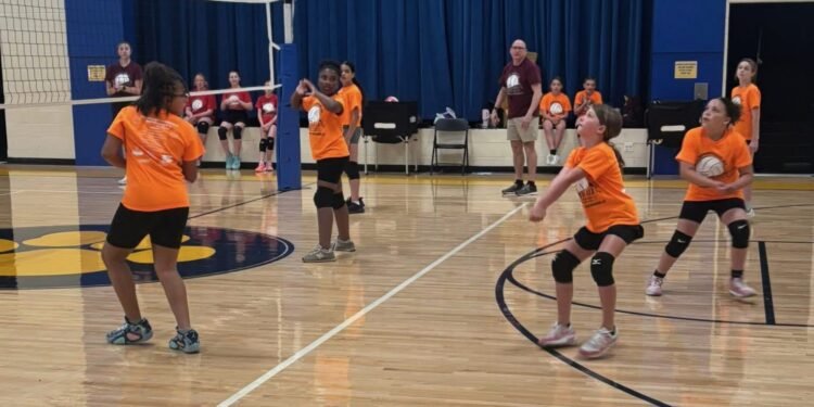 Girls learn volleyball in free, low-stress feeder program