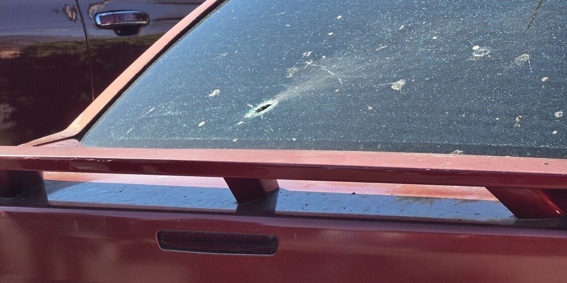Juvenile is grazed by bullet shot through rear window of car