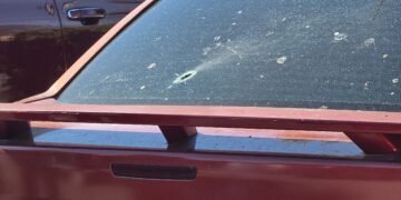 Juvenile is grazed by bullet shot through rear window of car